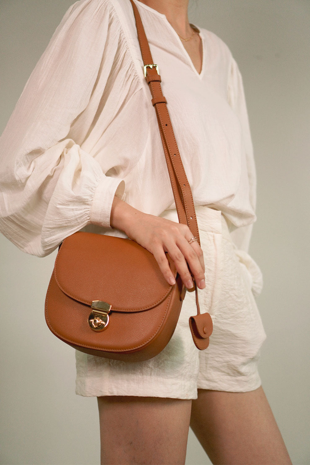 Huns Saddle Bag in Gold worn as a shoulder bag, can also be styled as a sling bag