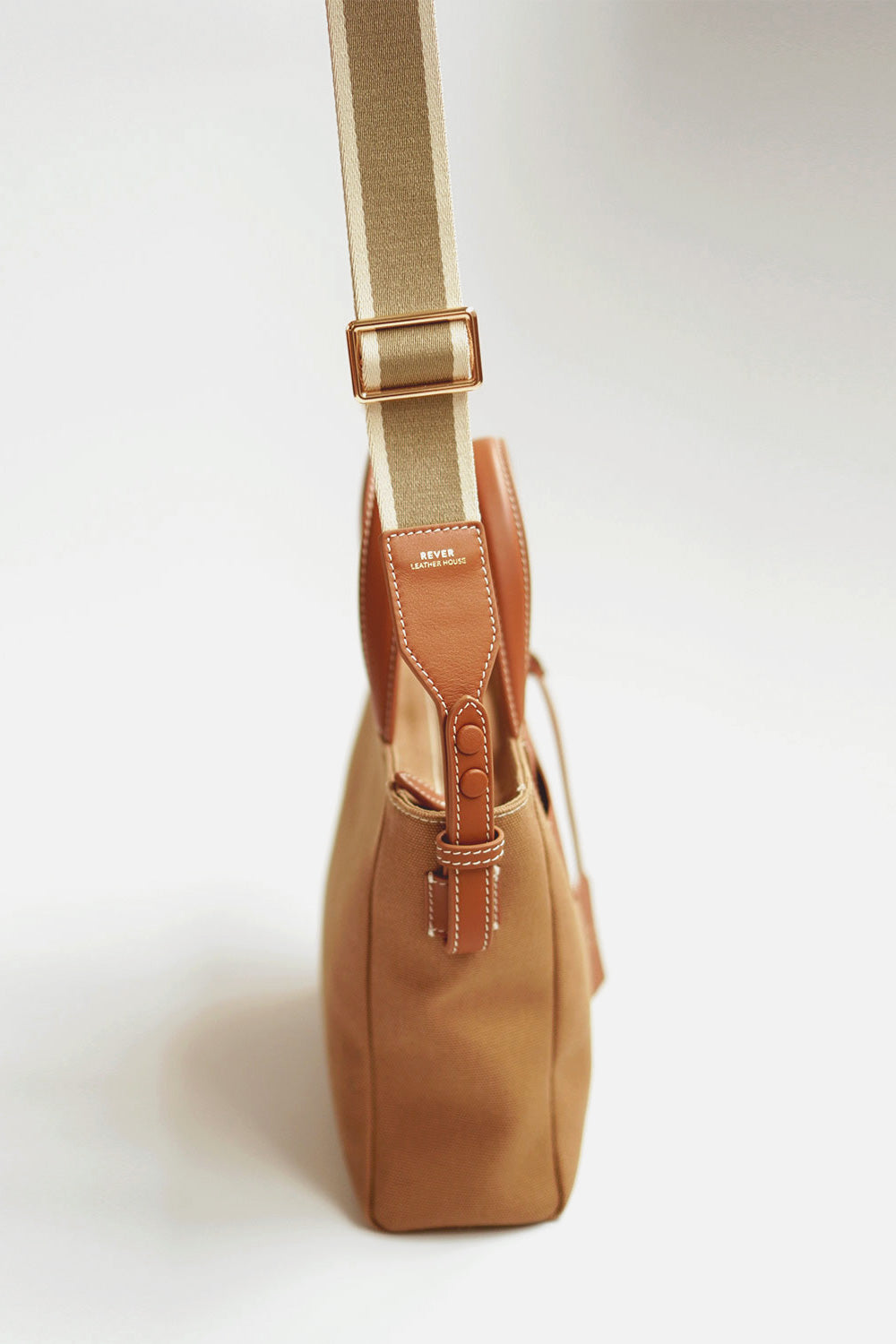 Adjustable leather bag strap for Daley Mini Canvas Tote Bag, showing side view after installation for crossbody or shoulder wear.