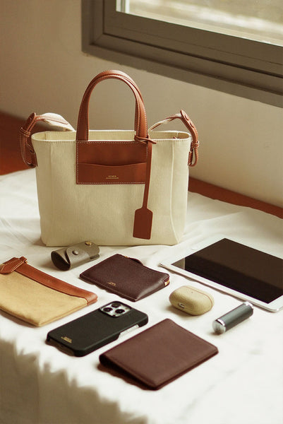 Daley Mini Canvas Tote Bag in Singapore, with essentials displayed outside to show what fits inside the tote bag.