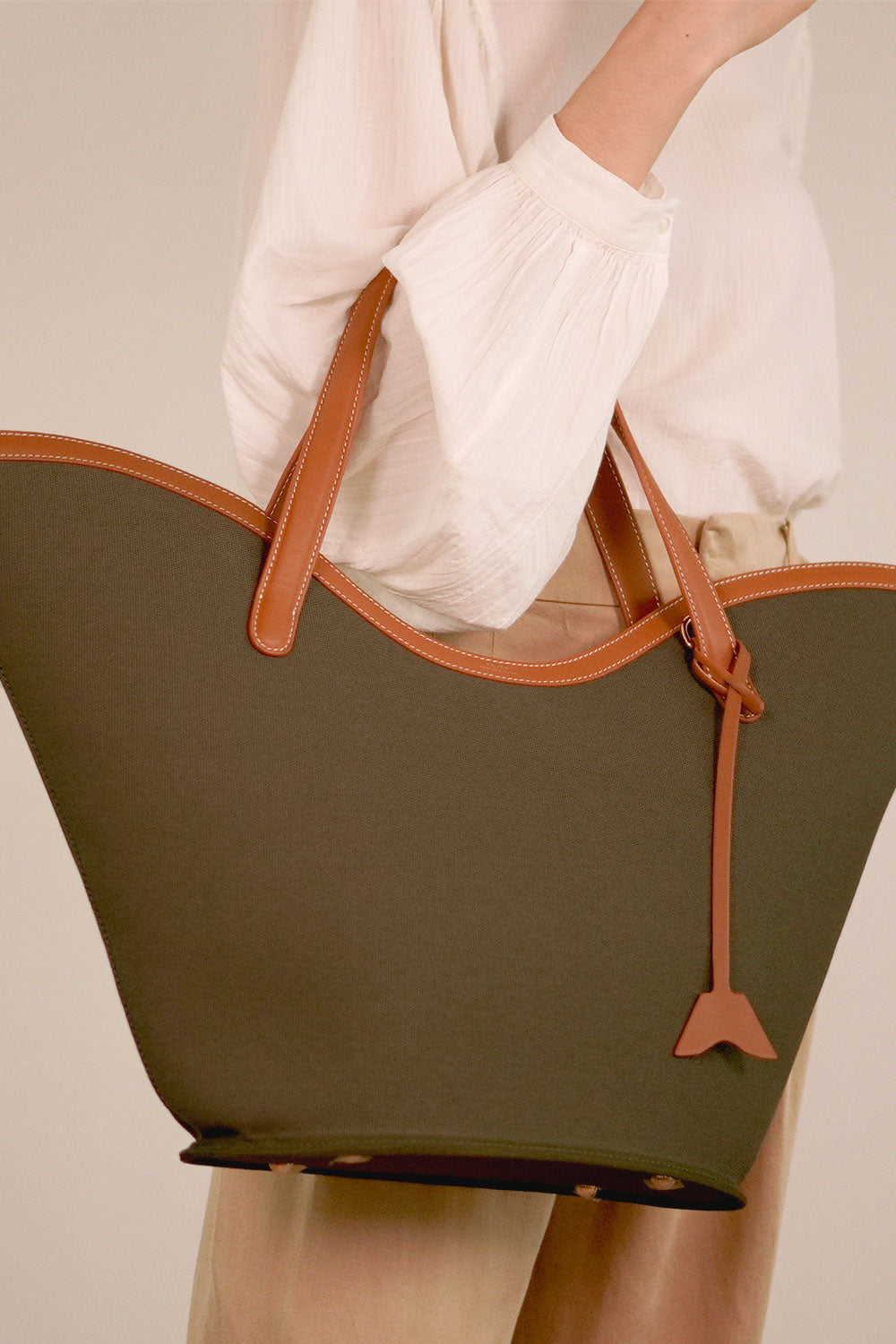 Personalised Canvas Tote Bag in Olive, canvas and leather bag in Singapore, model holding at elbow.