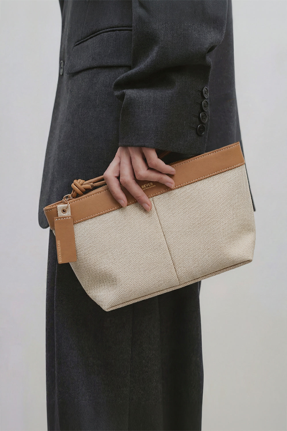 Basics Pouch in Honey Oat held by model