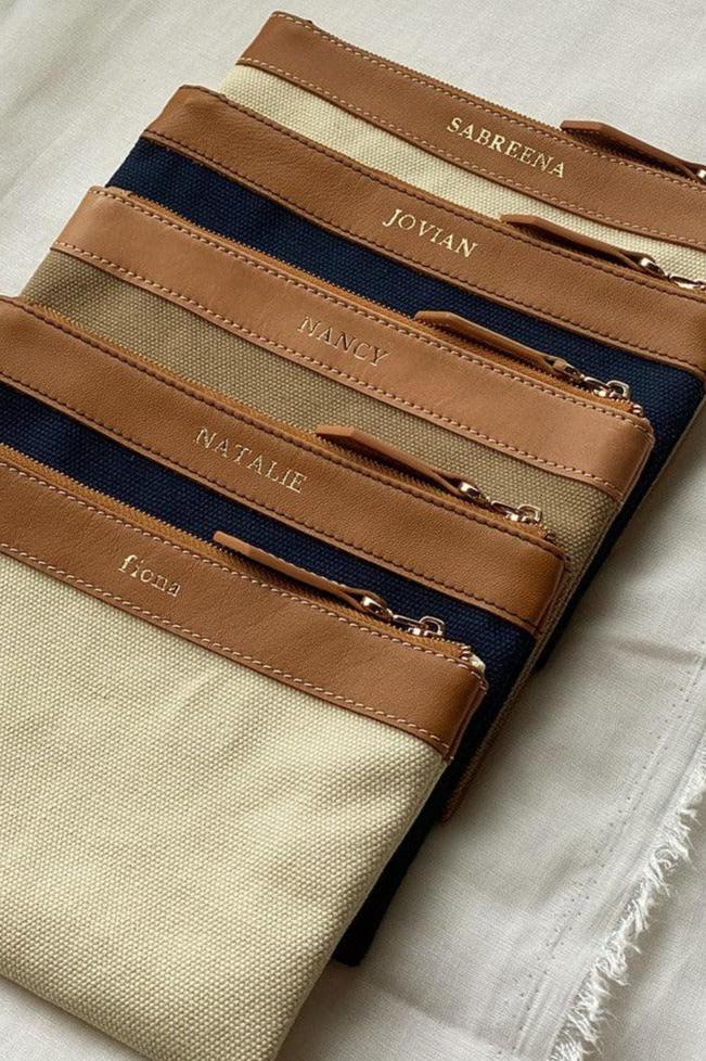 Set of 5 leather zip personalised pouches in assorted colours, ideal as Christmas gift exchange or corporate gifts in Singapore.